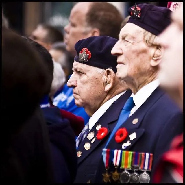 Two veterans in the crowds along King Street in Hamilton